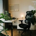 Modern home office workspace with desk, laptop, and plants
