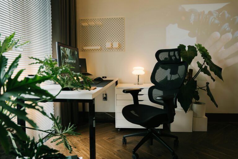 Modern home office workspace with desk, laptop, and plants